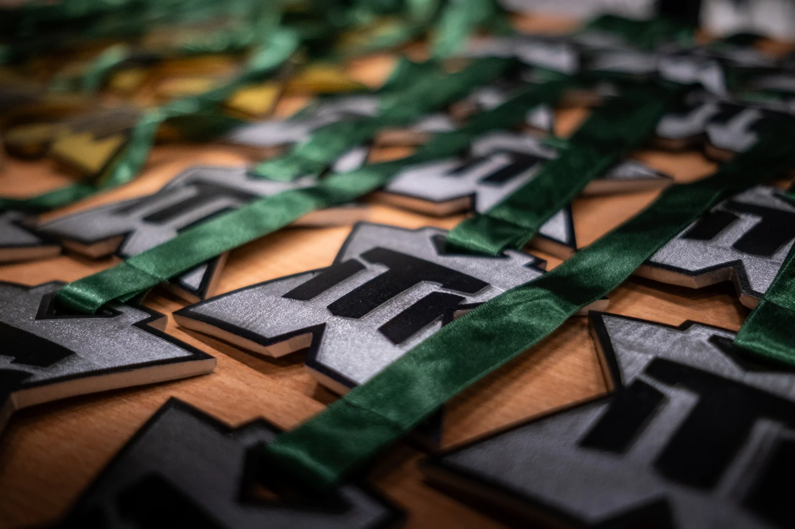 EMT logo letters close-up with green satin ribbons — awards and atmospheric markers of the event