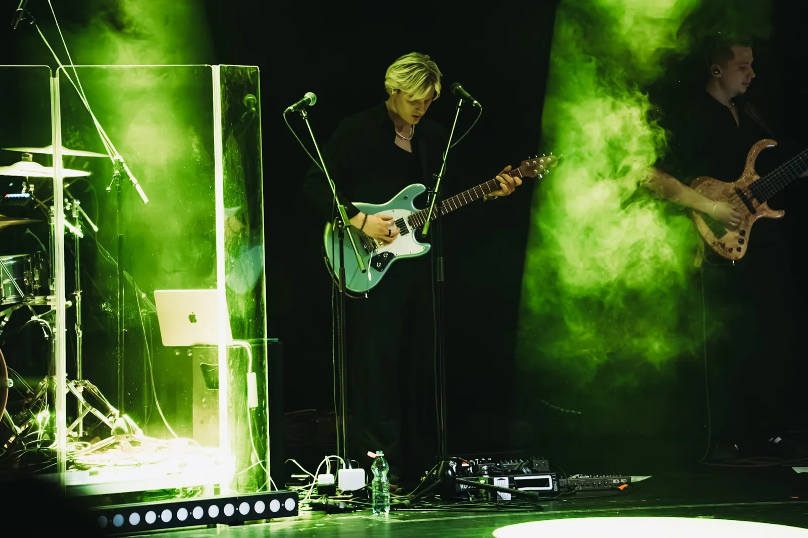 Guitarist at the concert in green lighting