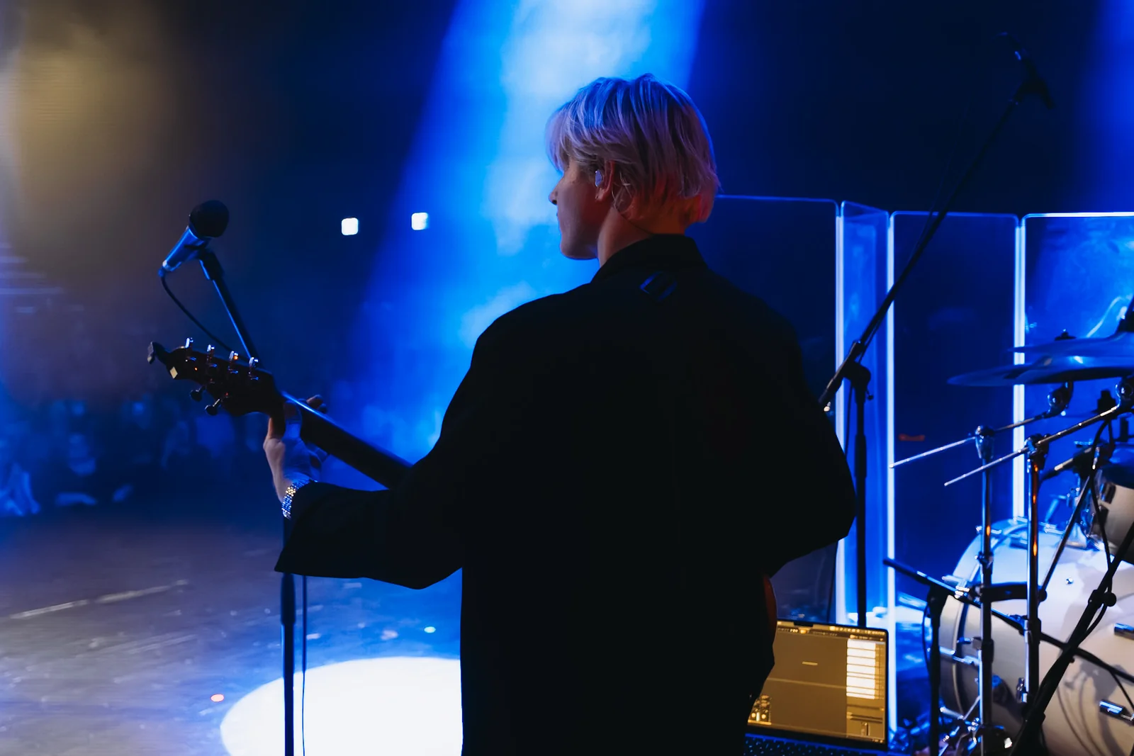 Veréb Tamás on stage at the Budapest concert with guitar and a visible in-ear monitor — using Pantheon Sound's IEM system
